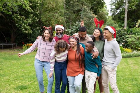 Joyful family gathering outdoors with festive hats