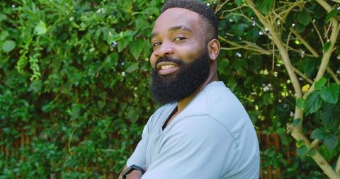 Confident Man in Garden Embracing Nature and Wellness