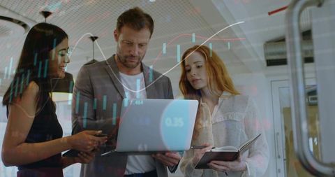 Corporate team analyzing live stock market charts on laptop collaborating on strategy
