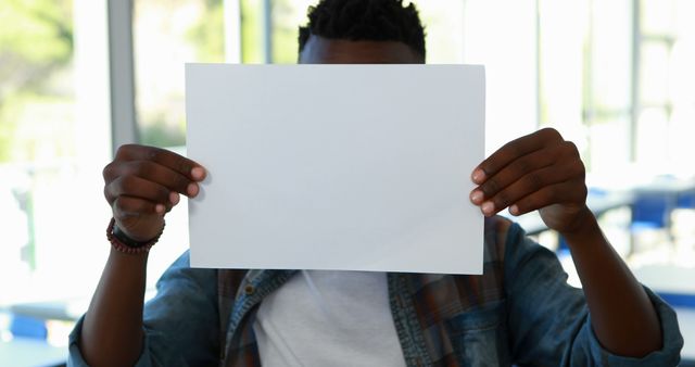 Person Holding Blank Sheet of Paper in Bright Room - Download Free Stock Images Pikwizard.com