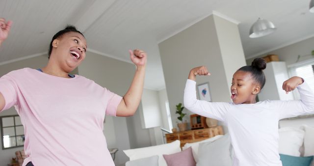 Mother and Daughter Flexing Muscles and Smiling - Download Free Stock Images Pikwizard.com