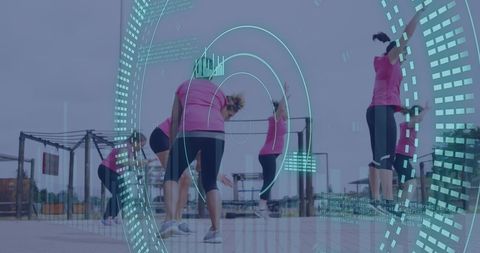 Diverse Women Exercising at Outdoor Obstacle Course with Digital Data Interface