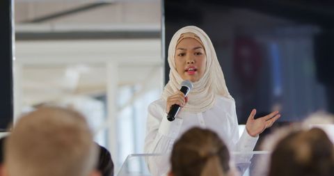 Young Woman in Hijab Speaking at Business Conference