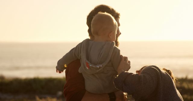 Young Family Enjoying Sunset at Tranquil Beach - Download Free Stock Images Pikwizard.com