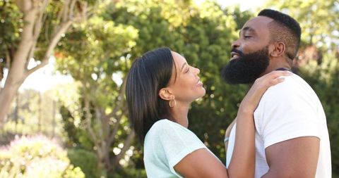 Romantic Couple Embracing in Sunlit Garden