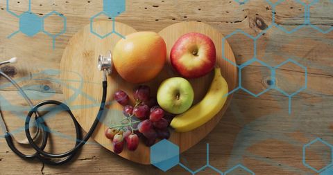 Healthcare Concept with Fresh Fruit and Stethoscope on Wooden Background
