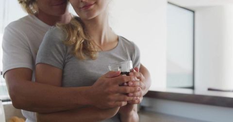 Affectionate Couple Enjoying Intimate Moment in Modern Kitchen