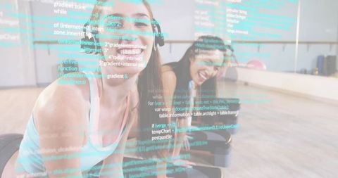 Women laughing and exercising on mats with code overlay representing fitness app technology