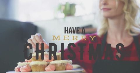 Baker Arranging Cupcakes with Joyful Christmas Wishes