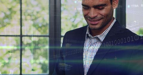 Smiling executive glancing down with digital data overlay in sunlit office headshot