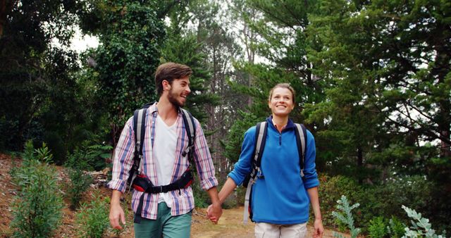 Couple Hiking Together Wearing Backpacks in Forest - Download Free Stock Photos Pikwizard.com