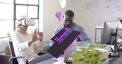 Woman in headscarf using vr in modern office space with coworker