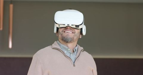 Man Wearing VR Headset Experiencing Virtual Reality in Modern Setting