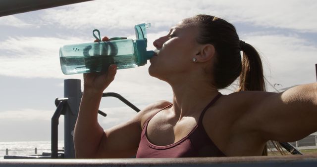 Female Athlete Hydrating at Outdoor Gym on Sunny Day - Download Free Stock Images Pikwizard.com