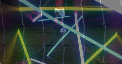Soccer player taking penalty with dynamic neon lights
