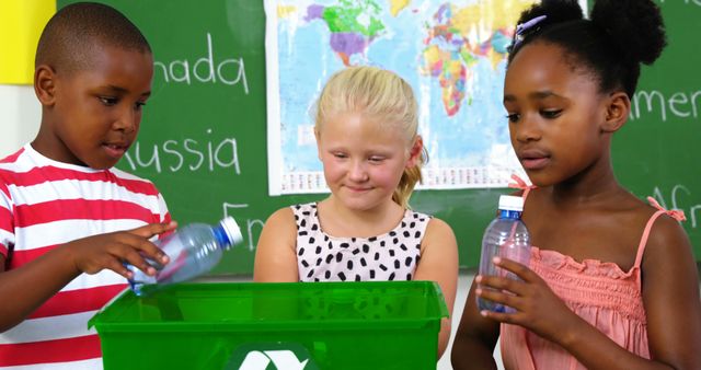 School kids putting waste bottle on recycle logo box in classroom at school 4k