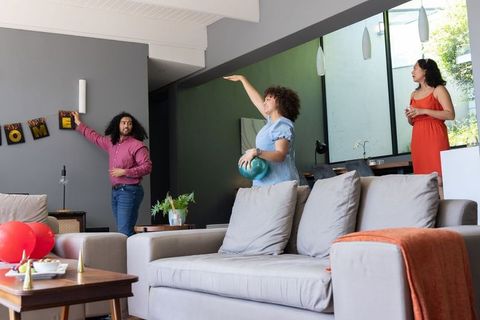 Diverse Friends Decorating for Cozy Housewarming Celebration