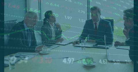 Executives Discussing Market Data and Financial Charts in Modern Boardroom with Laptops