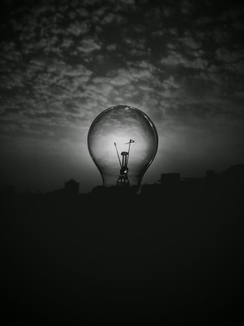 Silhouette of Light Bulb Against Dramatic Sky - Download Free Stock Photos Pikwizard.com