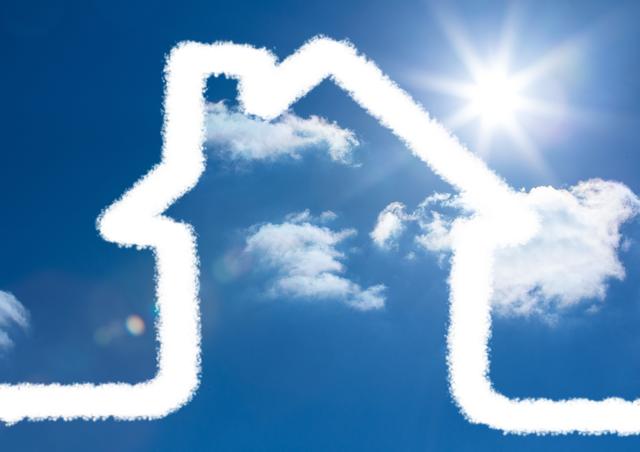 This image depicts a cloud shaped like a house against a bright blue sky with the sun shining. It can be used for real estate promotions, advertisements for dream homes, or creative projects related to home and imagination. Ideal for websites, brochures, and social media posts.