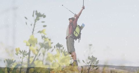 Triumphant Hiker Celebrating atop Scenic Hill