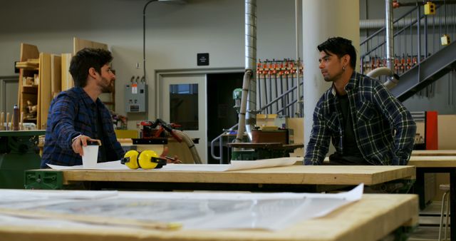 Two Male Carpenters Discussing Blueprint in Workshop - Download Free Stock Images Pikwizard.com