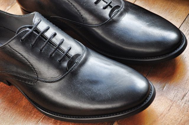Close-Up of Black Leather Dress Shoes on Wooden Floor - Download Free Stock Photos Pikwizard.com