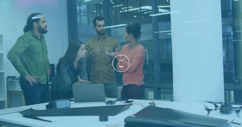 Diverse team collaborating in modern tech office environment