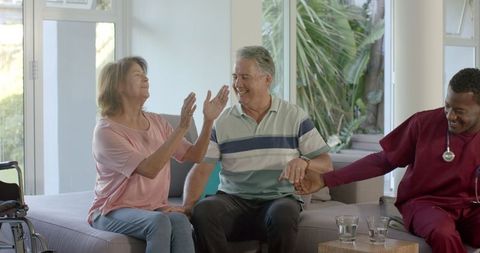 Senior Couple Enjoying Social Time with Healthcare Worker