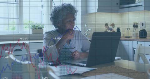 Elderly Woman Analyzing Stock Market Data on Laptop
