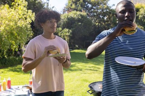 Friends Enjoying Outdoor Barbecue with Burgers