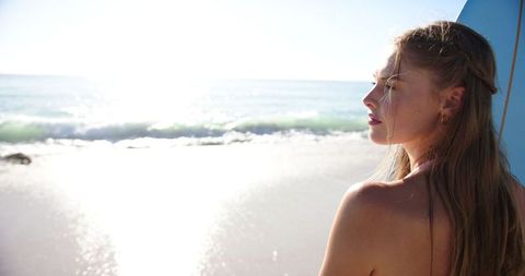Young Woman Enjoying Peaceful Beach View Contemplating Ocean Waves - Download Free Stock Images Pikwizard.com