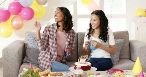 Joyful Birthday Celebration with Smiling Women and Colorful Balloons