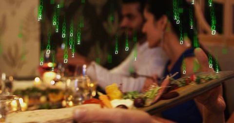 Candlelit dinner with charcuterie board and green binary code overlay for cybersecurity