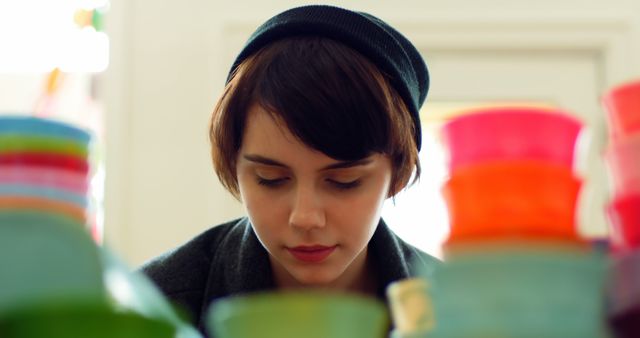 Young Person Browsing Plastic Containers in Store - Download Free Stock Images Pikwizard.com