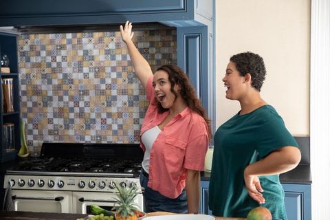 Female friends enjoying time together in sophisticated kitchen