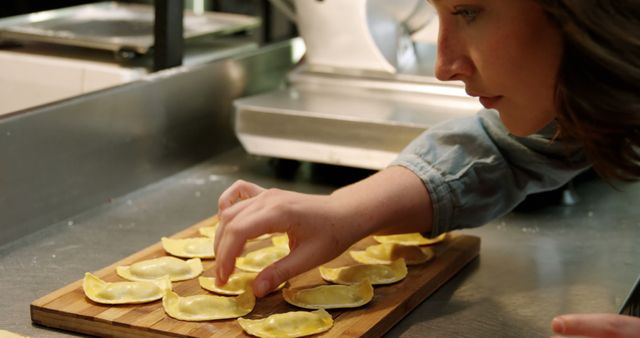 Caucasian female chef looking on dumplings in restaurant kitchen - Download Free Stock Photos Pikwizard.com