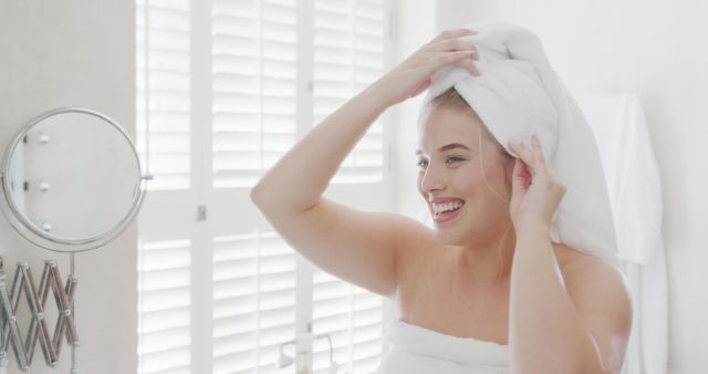 Woman Wrapping Hair in Towel After Shower in Sunlit Bathroom - Download Free Stock Images Pikwizard.com