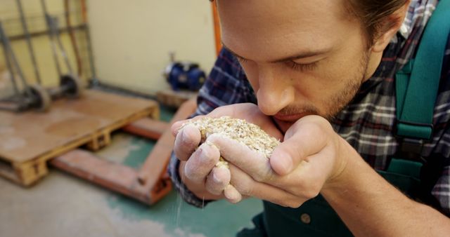 Male Farm Worker Examining Grain in Warehouse - Download Free Stock Images Pikwizard.com