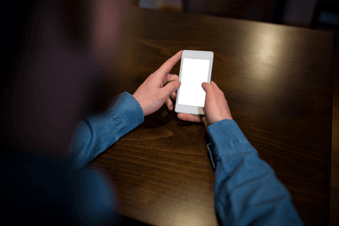 Transparent Smartphone Screen Being Held at Wooden Cafe Table - Download Free Stock Videos Pikwizard.com