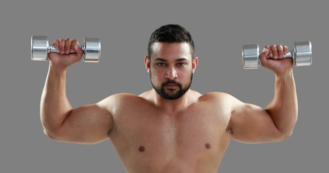 Muscular Man Exercising with Dumbbells on Gray Background - Download Free Stock Images Pikwizard.com