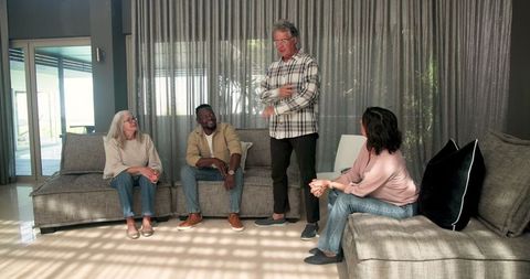 Senior man leading therapy session with engaged participants