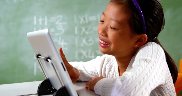 Smiling Schoolgirl Engaged with Digital Tablet in Classroom - Download Free Stock Images Pikwizard.com