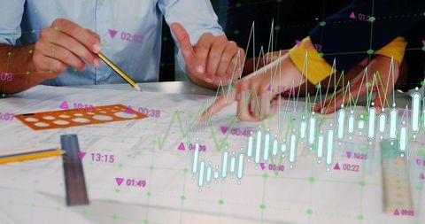 Team tracing and pointing over blueprint with financial chart overlay and analytics