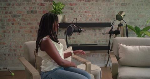 Recording intimate podcast interview with female host in cozy brick home studio