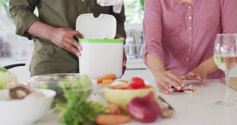 Couple Cooking Together and Managing Kitchen Waste