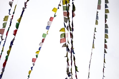Colorful tibetan prayer flags hanging against clear sky