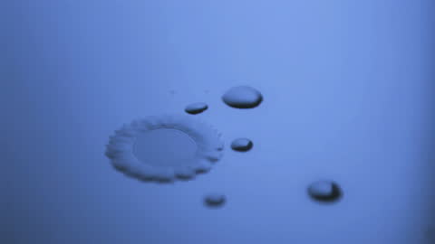 Drops Dancing in Slow Motion Under Calming Blue Light