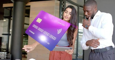 Colleagues Examining Virtual Bank Card Graphic in Modern Office