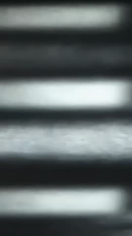 Shifting Sunlight Sliding Across Horizontal Metal Blinds Vertical Video Loop for Backgrounds